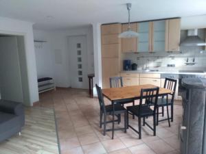 a kitchen and dining room with a wooden table and chairs at Ferienwohnung Zechner in Waidring