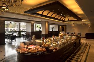 a buffet line in a hotel with food on it at Ramada by Wyndham Bahrain in Manama