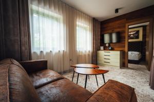 a living room with a couch and a table at Guest House EJGA in Jesenice