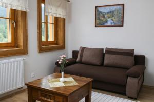 a living room with a couch and a coffee table at Koliba Hubertka in Oravice