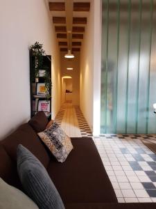 a living room with a couch and a tile floor at Het Pakhuis Schiedam in Schiedam
