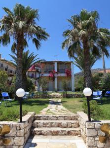 a resort with palm trees and a stone path at Aegealis Studios in Skala Kefalonias