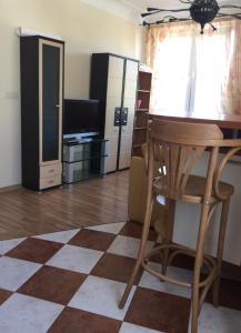 a living room with a table and a stool at Old Town apartament in Šiauliai