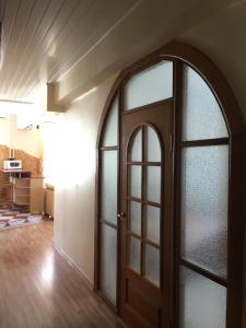 an arched glass door in a living room at Old Town apartament in Šiauliai