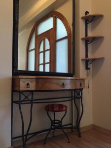a dressing table with a mirror and a stool at Old Town apartament in Šiauliai