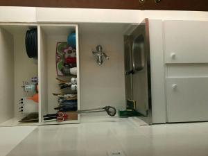 a kitchen with a cabinet with a mirror and a refrigerator at Grattacielo alla Stazione in Sannicandro Garganico