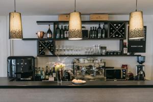 a bar with a counter with bottles of wine at meerzeit Hotel in Cuxhaven