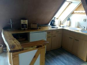 a kitchen with a counter and a sink and a window at Haus Speck 5 in Kargow