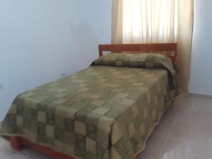Postel nebo postele na pokoji v ubytování Apartamentos Nuevo Amanecer