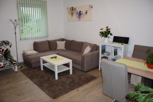 a living room with a couch and a table at Ferienwohnung Albel in Velden am Wörthersee