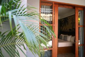 Postel nebo postele na pokoji v ubytování De Rekun Ubud