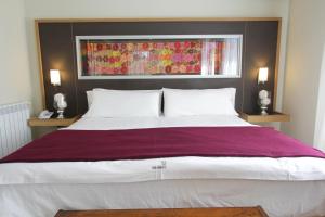 Cama ou camas em um quarto em Plaza Paradiso Petit Hotel