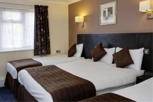 A bed or beds in a room at BEST WESTERN Gatwick Skylane Hotel