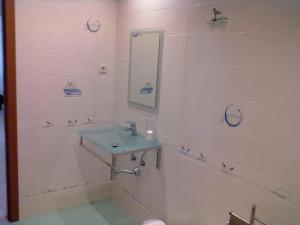 a bathroom with a sink and a tub and a mirror at Ericeira - Apartment with Patio - Horizonte Mar in Ericeira