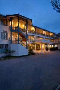 a hotel room with a large white building behind it at Devasom Hua Hin Resort - SHA Extra Plus in Cha Am