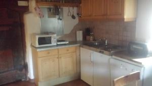 a kitchen with a sink and a microwave at Turmhaus am Perschlhof in Murau +11 photos