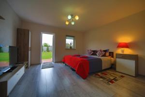 a bedroom with a bed and a flat screen tv at Pensjonat pod Dębami in Świnoujście