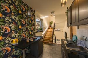 a kitchen with a wall with a colorful wallpaper at 5 kroków in Zakopane