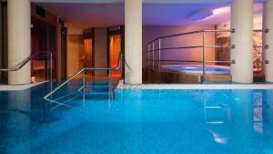 a hotel swimming pool with a hot tub at Villa Fenix in Ustronie Morskie