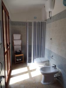 a bathroom with a toilet and a shower and a sink at Meravisola Costa Rei in Castiadas +58 photos