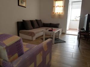 a living room with a couch and a table at Ani in Povljana
