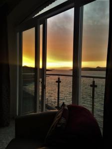 a room with a window with a view of the ocean at Curlew Apartment in Valentia Island