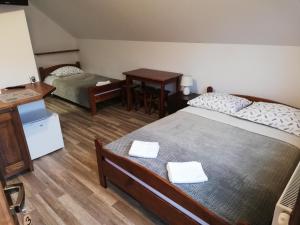 Ένα ή περισσότερα κρεβάτια σε δωμάτιο στο Sloneczna Kwatera