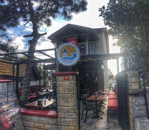 a restaurant with tables and a sign on a building at Görkemli Hotel in Istanbul