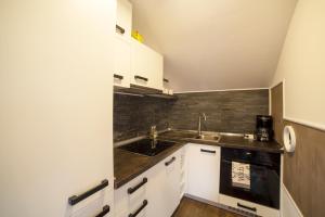 a small kitchen with a sink and a stove at Casa City View in Sibiu