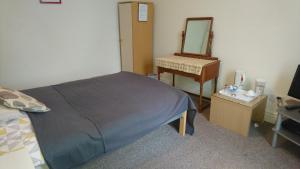 Postel nebo postele na pokoji v ubytování Arman Lodge House