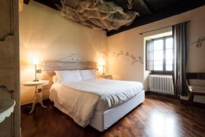 a bedroom with a large bed and a window at Borgo Casale in Albareto
