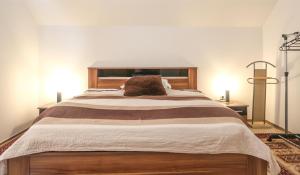 a large bed in a bedroom with two lamps at Sunnyside Villa in Sarajevo