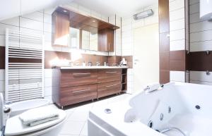 a bathroom with a tub and a toilet and a sink at Sunnyside Villa in Sarajevo +42 photos