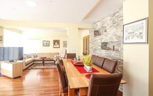 a dining room and living room with a table and chairs at Sunnyside Villa in Sarajevo