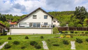 a large white house with a garden in front of it at Sunnyside Villa in Sarajevo