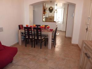 a dining room with a table with chairs and a mirror at 6 rue de la tourraque in Antibes