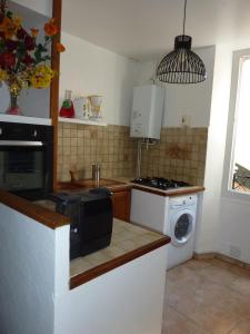 a kitchen with a stove and a microwave at 6 rue de la tourraque in Antibes