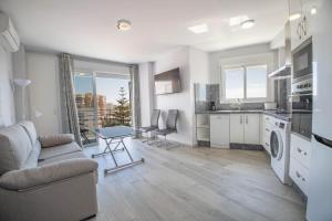 sala de estar con sofá y mesa en Precioso apartamento al lado de la playa, en Benalmádena