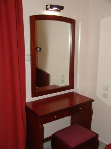 a bathroom with a wooden vanity and a mirror at Hotel Cosmos in Athens