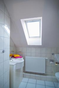 a bathroom with a sink and a skylight at Oll Deep Kate in Dornumersiel +34 photos