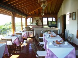a restaurant with white tables and chairs and tablesearcher at Pensión Bella Vista in Cóbreces