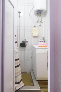 a small bathroom with a shower and a sink at Jelena Joksic in Trebinje