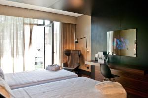 Tempat tidur dalam kamar di Evidencia Belverde Hotel
