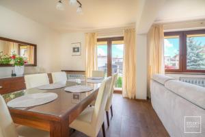 a dining room with a table and a couch at VIKTORIA Wadowice in Wadowice