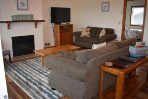 a living room with a couch and a fireplace at Coquille Point Condo in Bandon