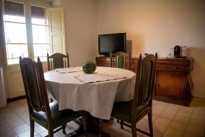 a dining room with a table and a television at Ca l'Anyep-L'Ermita in El Vilosell