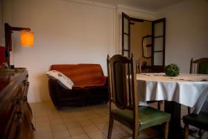 a room with a table and a chair and a mirror at Ca l'Anyep-L'Ermita in El Vilosell