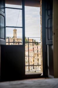 an open window with a view of a building at Ca l'Anyep-L'Ermita in El Vilosell