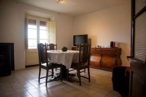 a dining room with a table and chairs and a television at Ca l'Anyep-L'Ermita in El Vilosell +7 photos