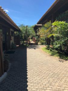 a cobblestone walkway in front of a house at Village Lagoa do Forte in Praia do Forte